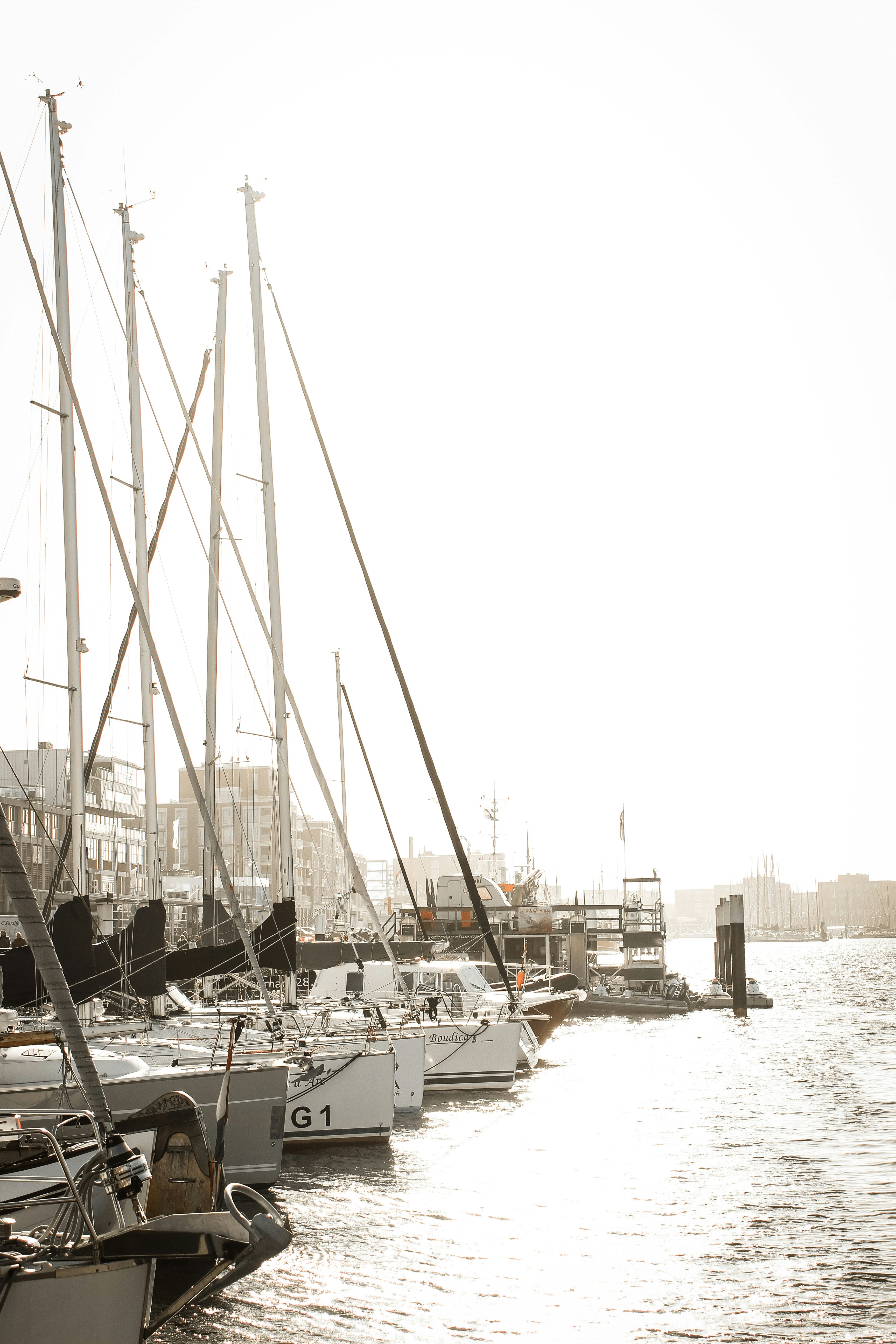 white sail boat on sea dock during daytime